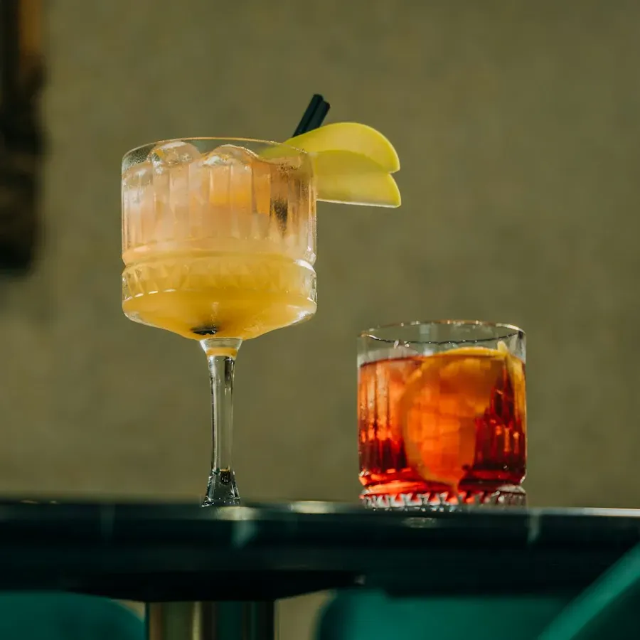 Two cocktails on a bar table
